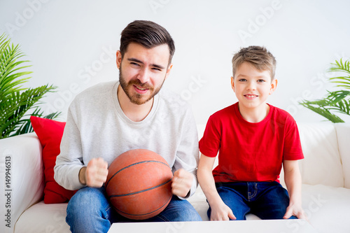 Father and son watching basketball