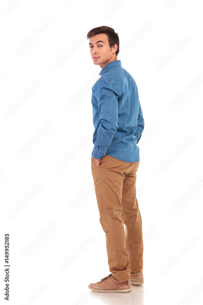 casual man looking back over his shoulder casual man looking back over his shoulder