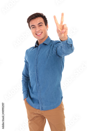 happy casual man making the victory or peace hand sign