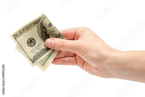 female hand takes or gives one hundred US dollars.
