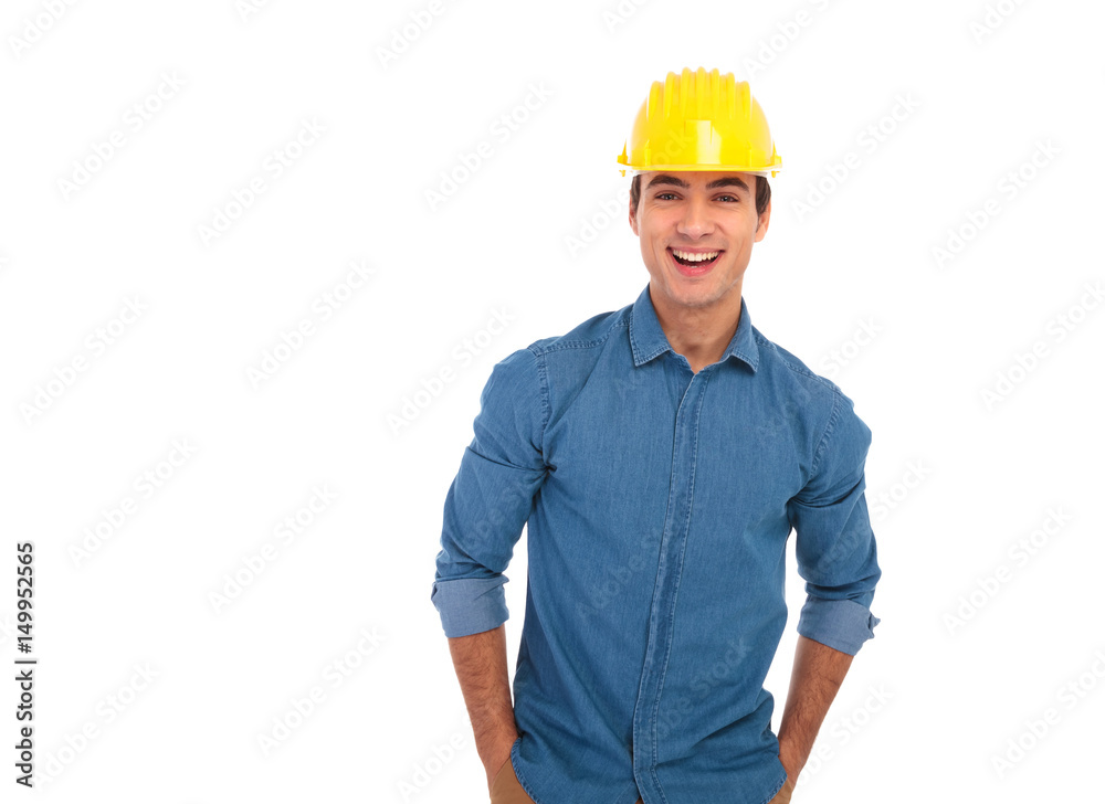 relaxed construction engineer with hands in pockets laughing relaxed construction engineer with hands in pockets laughing