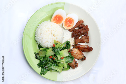 stir fried vegetables, Hard-boiled egg, Fried pork and Fried chicken wings with thai jasmine rice on dish. Thai food.