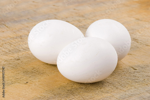 Three eggs on old wooden background