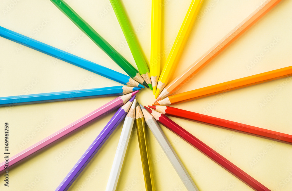 Business concept - Top view of color pencil circle on yellow paper background, teamwork, united and communication concept Business concept - Top view of color pencil circle on yellow paper background, teamwork, united and communication concept