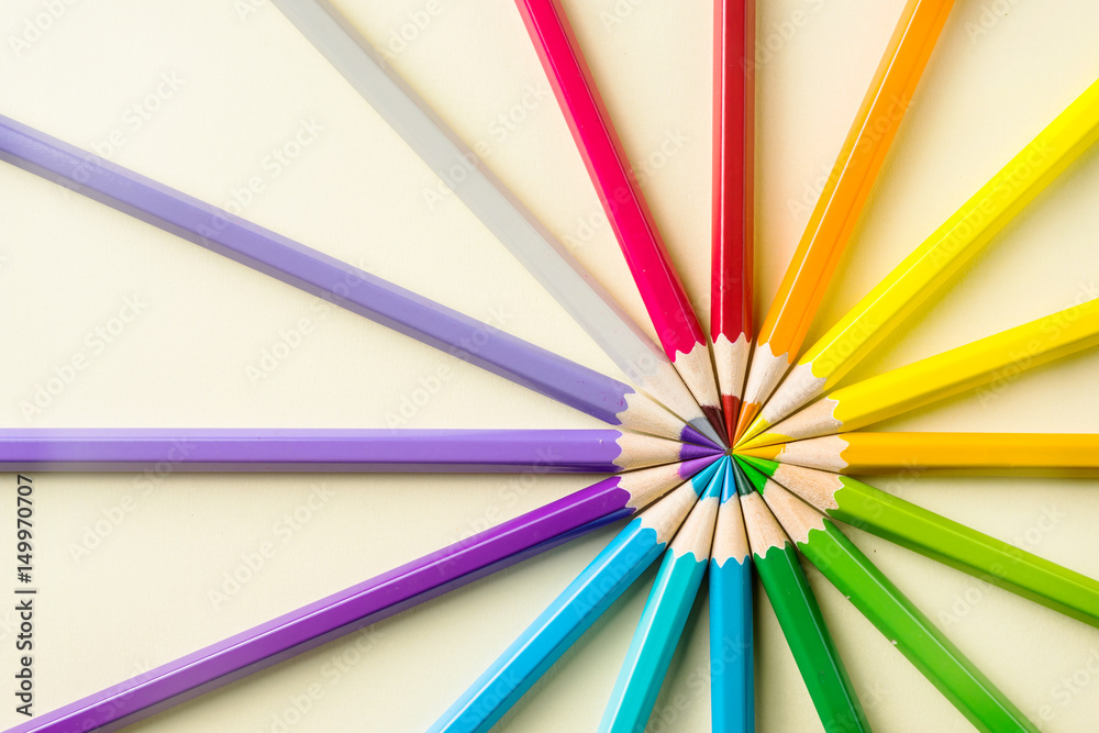 Art concept - Top view of color pencil wave on yellow paper background for mockup design Art concept - Top view of color pencil wave on yellow paper background for mockup design