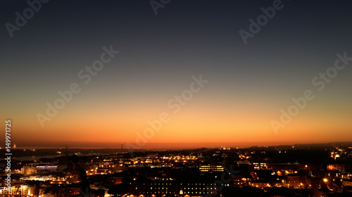 City night from the view point on top of hill at beautiful sunset. Bird view over the city at night with abstract urban night lights in Lisbon  Portugal