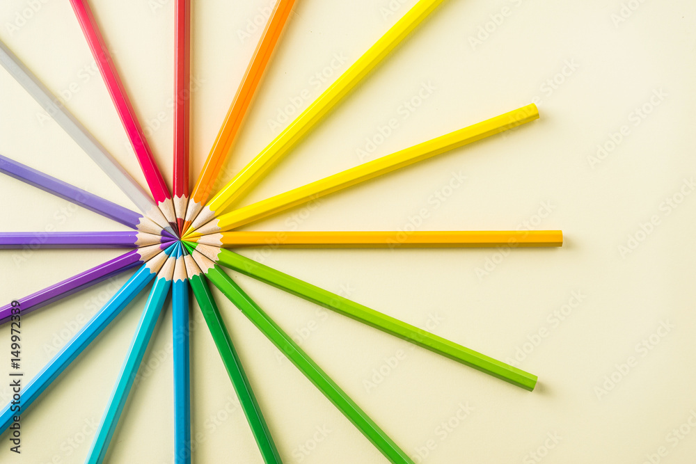 Art concept - Top view of color pencil wave on yellow paper background for mockup design Art concept - Top view of color pencil wave on yellow paper background for mockup design