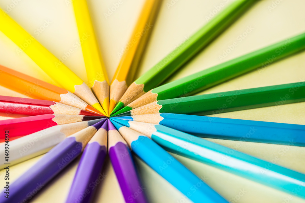 Art concept - Top view of color pencil wave on yellow paper background for mockup design Art concept - Top view of color pencil wave on yellow paper background for mockup design