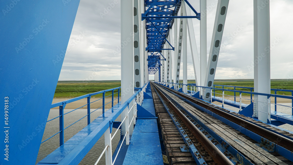 Fototapeta premium Railway bridge across the Yuribey river on the Yamal Peninsula with a length of 3.9 kilometers