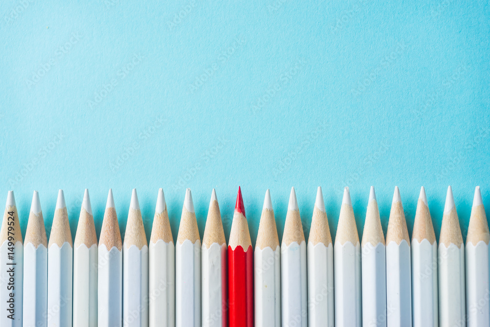 Business concept - lot of white pencils and color pencil on blue paper background. It's symbol of fight, leadership and communication. Business concept - lot of white pencils and color pencil on blue paper background. It's symbol of fight, leadership and communication.