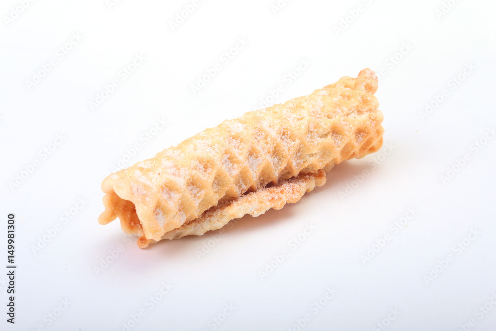 Homemade wafer rolls with powdered sugar isolated on white background Homemade wafer rolls with powdered sugar isolated on white background