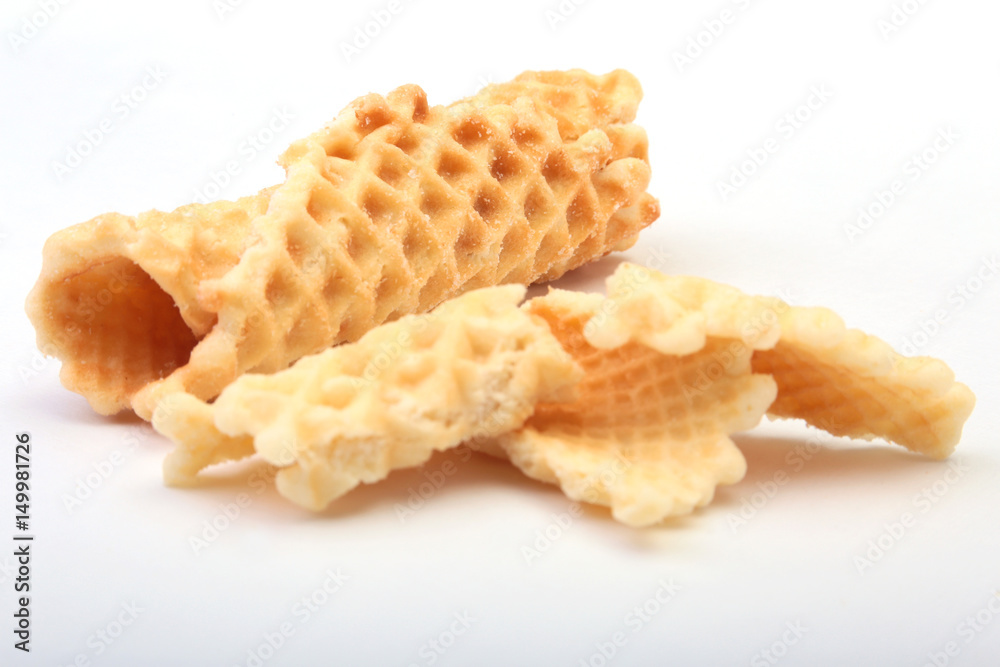 Homemade wafer rolls with powdered sugar isolated on white background