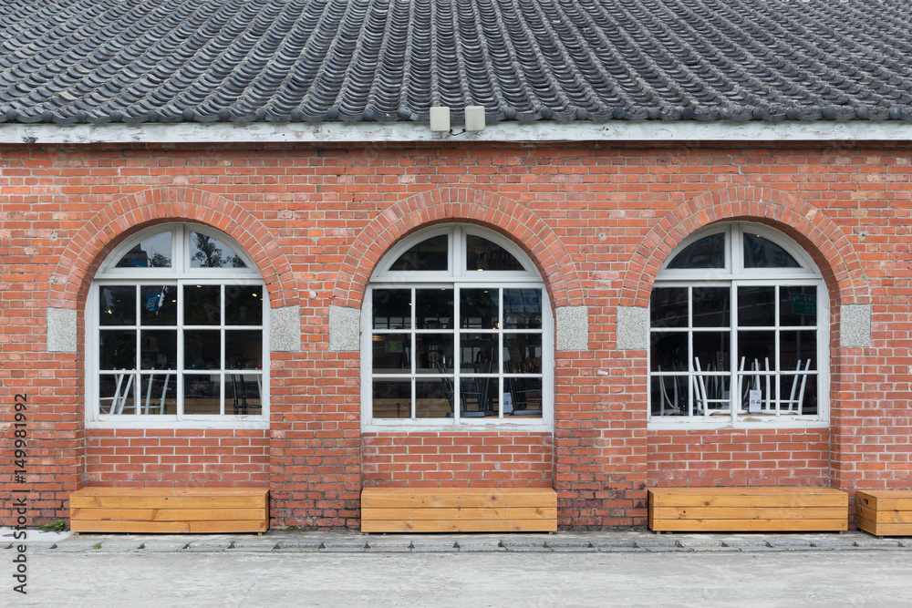 White painted wood with three red bricks wall arched windows White painted wood with three red bricks wall arched windows
