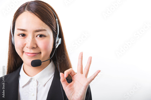 Happy smiling female customer support phone operator showing ok