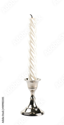 White candle in a candlestick isolated