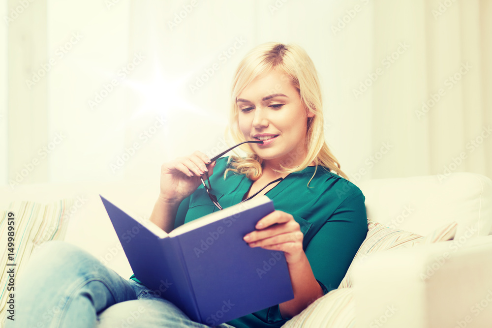 young woman with glasses reading book at home young woman with glasses reading book at home