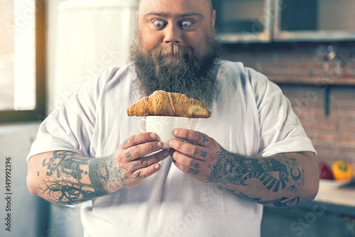 Man looking at a croissant