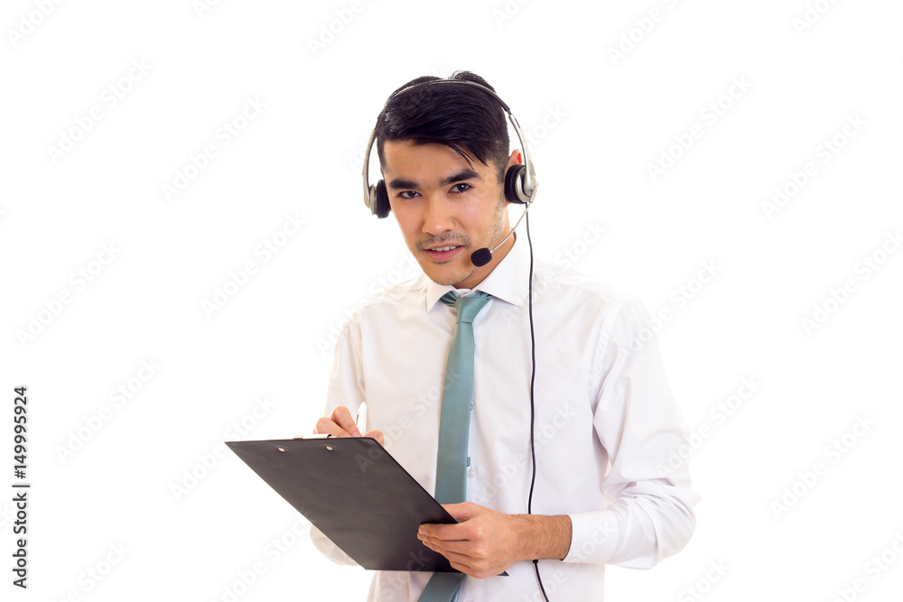 Young man using headphones and holding folder Young man using headphones and holding folder