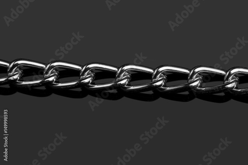 Chain heap - abstract metal background. Collection silver jewelry chains on an isolated black background. Set of different lenght metal chain. Accessories. Bijouterie. Silver.