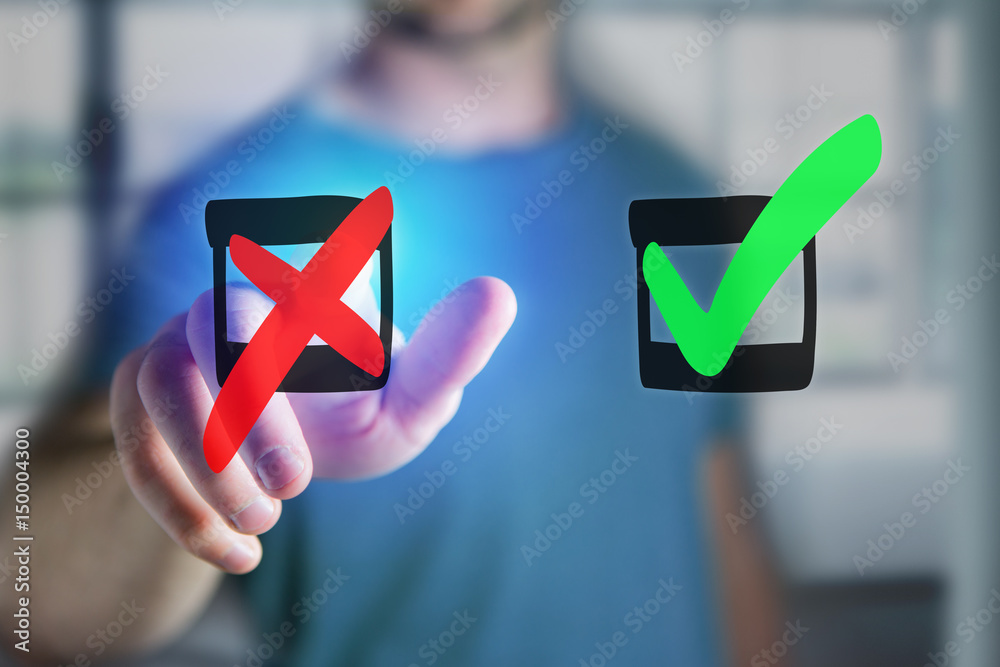Man finger touching a hand drawn red and green tick icon on a