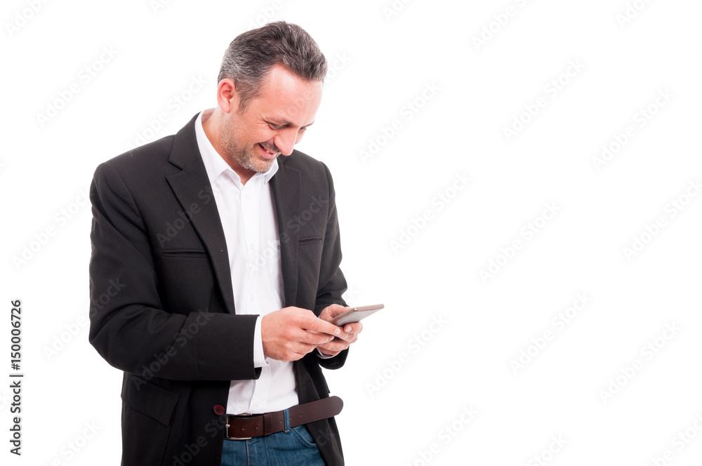 Happy young businessman reading text message on cellphone Happy young businessman reading text message on cellphone