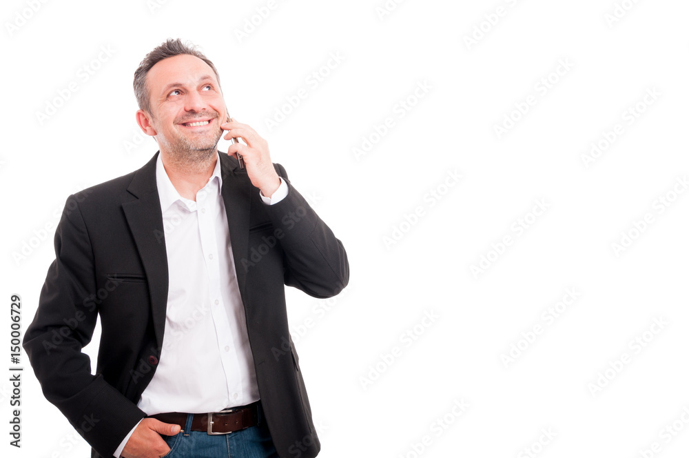 Charming young man talking on mobile phone Charming young man talking on mobile phone