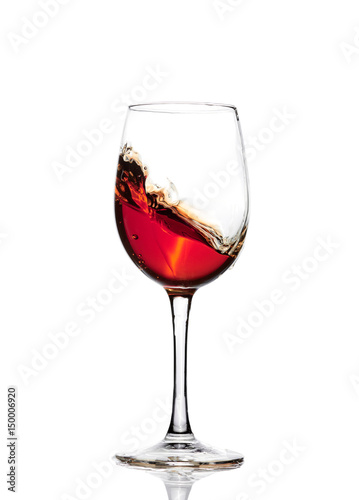 Classic Glass of Red Wine isolated on a white background. Splashing red wine in a glass. A splash of red wine in a glass. Grapes. Alcohol.