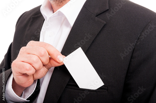 Closeup of entrepreneur putting business card in pocket