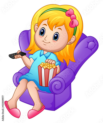 Girl sitting on a sofa watching a movie and eating popcorn