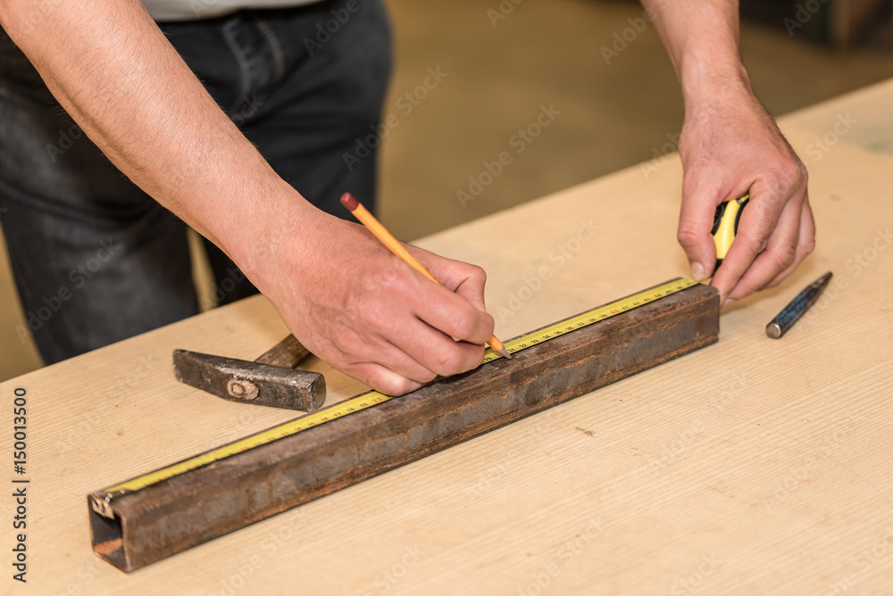 Man working and use a pencil and tape measure Man working and use a pencil and tape measure