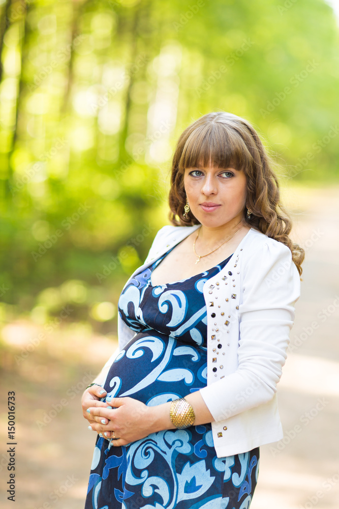 Portrait of young happy pregnant woman relaxing and enjoying life in nature. Outdoor shot. Portrait of young happy pregnant woman relaxing and enjoying life in nature. Outdoor shot.