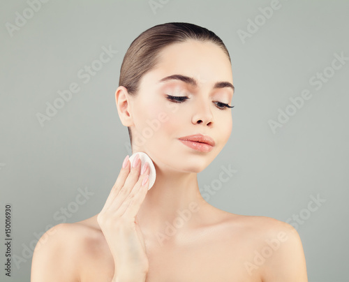 Cute Woman with Healthy Fresh Skin holding White Cotton Pads. Beautiful Face Closeup