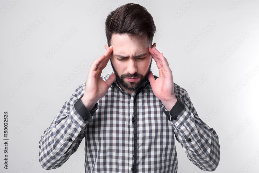 studenh holding his head with his hands. Businessman gets stress. Bearded man on a white background studenh holding his head with his hands. Businessman gets stress. Bearded man on a white background