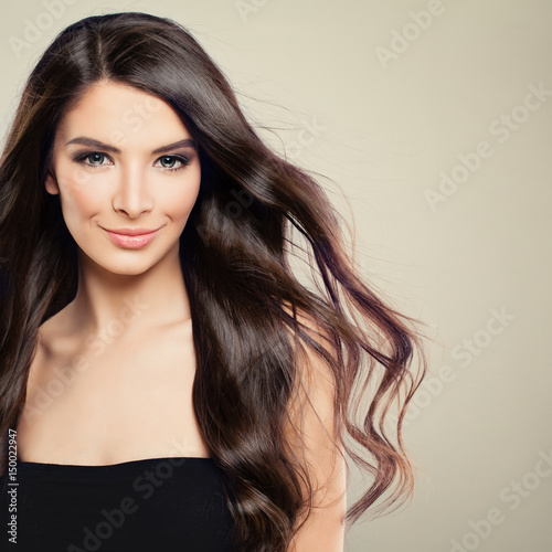 Perfect Young Woman with Blowing Hair. Beautiful Model with Hairstyle and Makeup