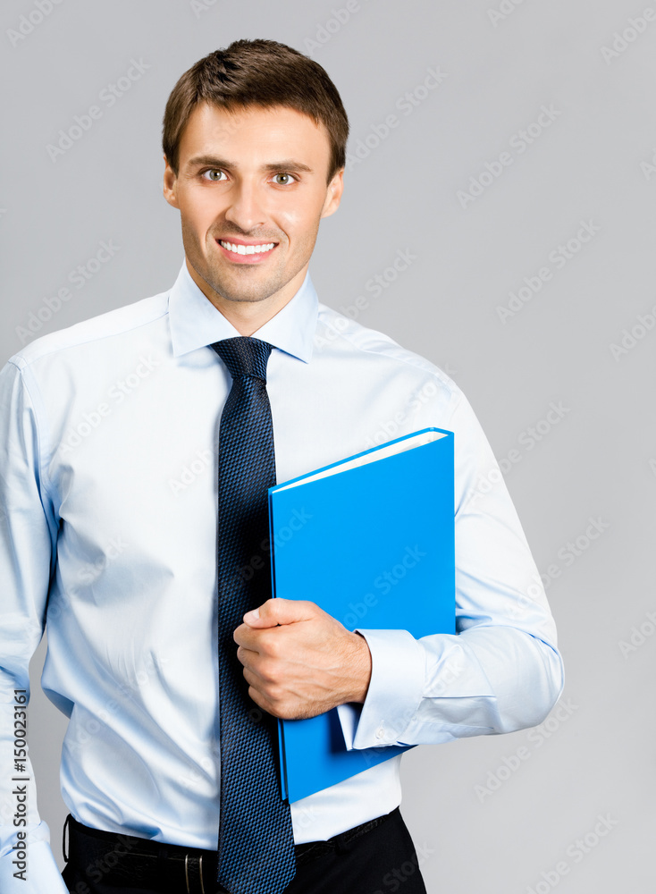 Portrait of business man with folder, over gray Portrait of business man with folder, over gray