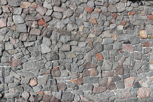 Rubble gray and brown stone wall, rubblework photo