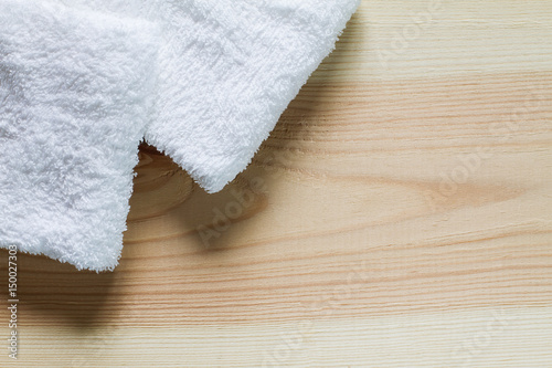 White towels with soft shadow on vintage wooden background,top view