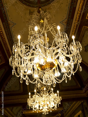 Chandelier hanging under a ceiling in a palace