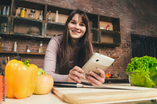 Beautiful woman looking at a tablet. photo