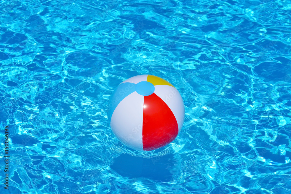 Colorful inflatable ball floating in swimming pool
