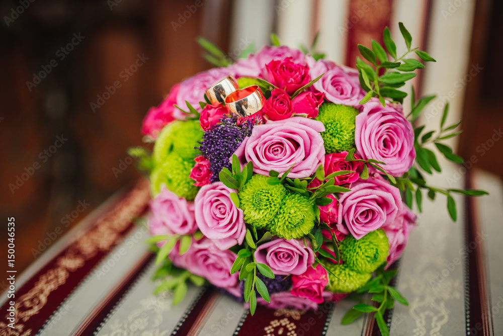 Obraz premium Wedding. Wedding bouquet and selective focusing rings Bouquet and accessories of bride and groom. Wedding closeup details