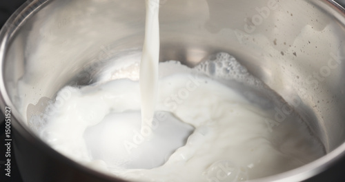 shot of pouring milk into saucepan, 4k photo