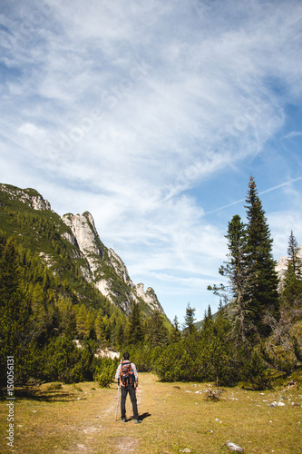 Man trekking / hiking in alpine scenery and nice weather.