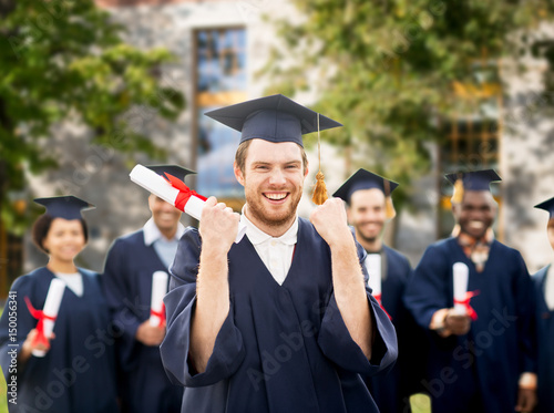 happy student with diploma celebrating graduation