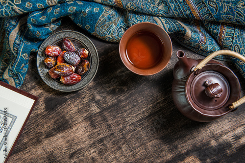 Ramadan of islam, date palm for Ramadan, date palm fruits and Tea on a metal tray placed on wood background.