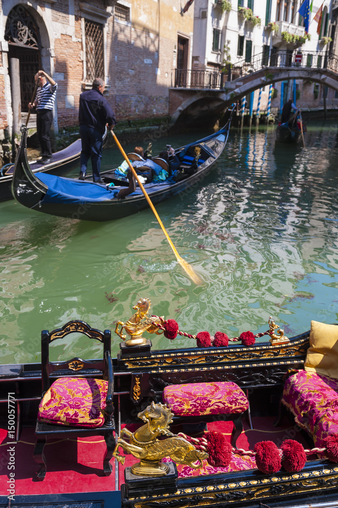 Scenic view of typical canal in Venice, Italy, with colorful gondola