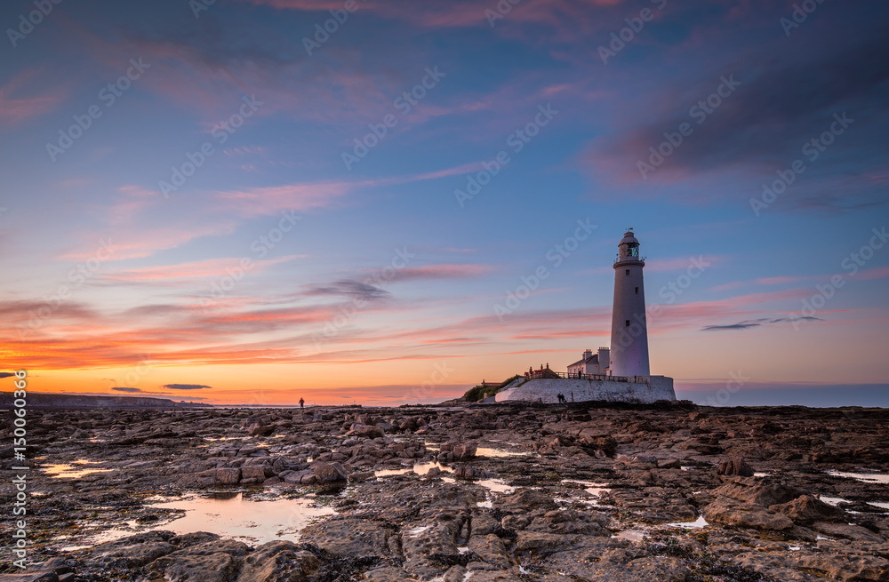 Dusk at St Mary's Lighthouse / St Mary's Lighthouse on a small rocky Island, just north of Whitley Bay on the North East coast of England. A causeway submerged at high tide links to the mainland