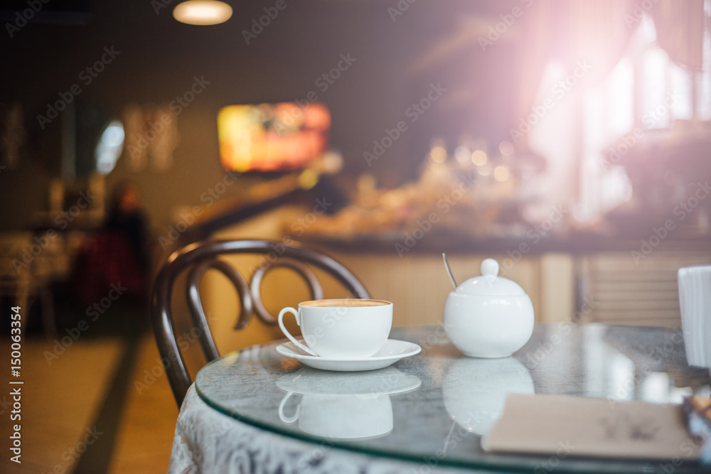 a restaurant or cafe interior with cup of coffee.