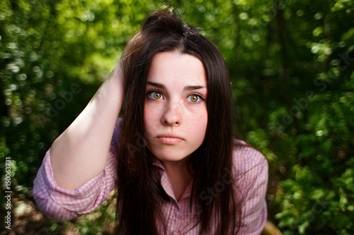 Portrait of attractive young pensive perplexed woman face close up