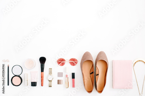 Beauty blog fashion concept. Female pink styled accessories: watches, sunglasses, cosmetics, shoes on white background. Flat lay, top view trendy feminine background.